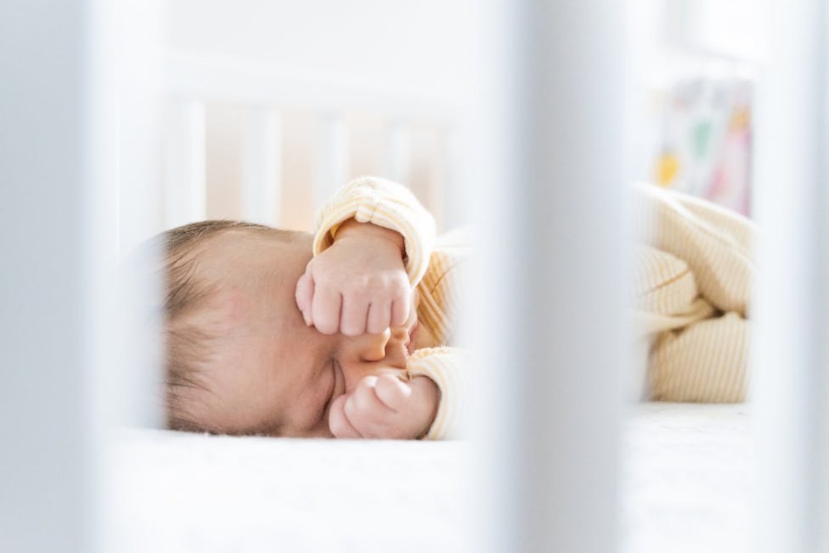 sleeping baby in crib with peaceful background