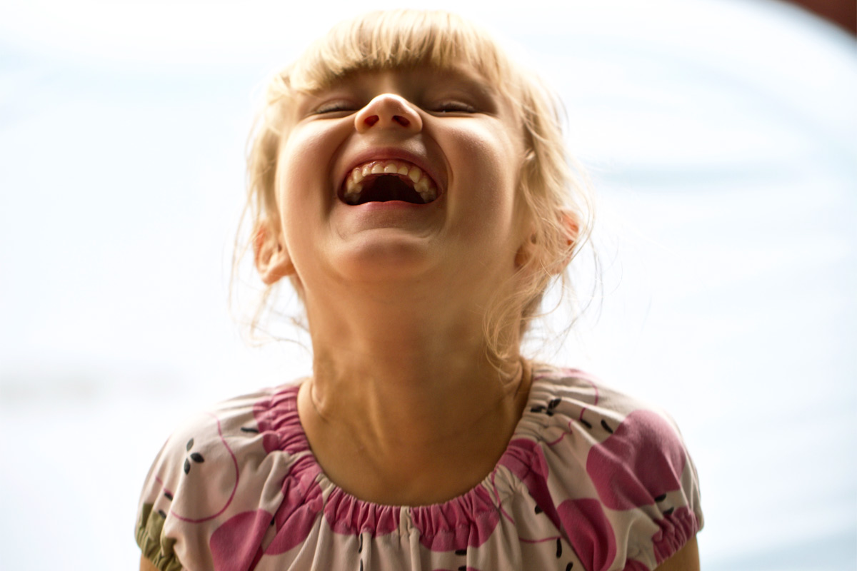 girl laughing at funny kids jokes