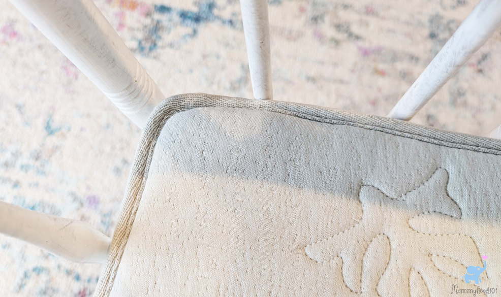 testing the fit of the katu crib mattress in a crib corner