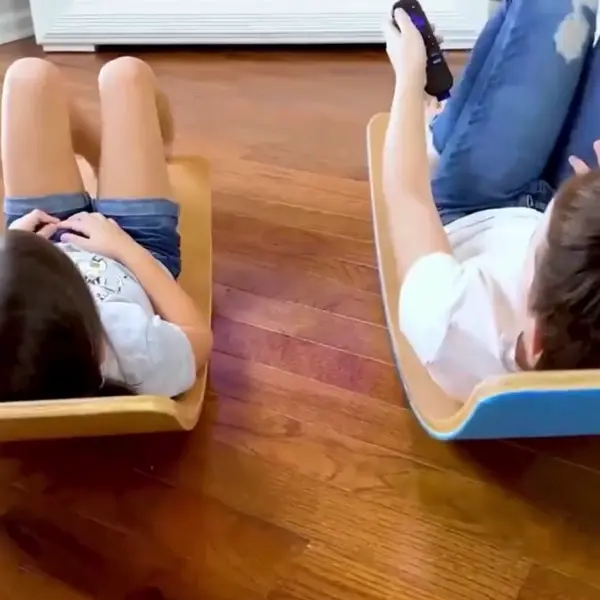 kids playing in various ways on a balance board