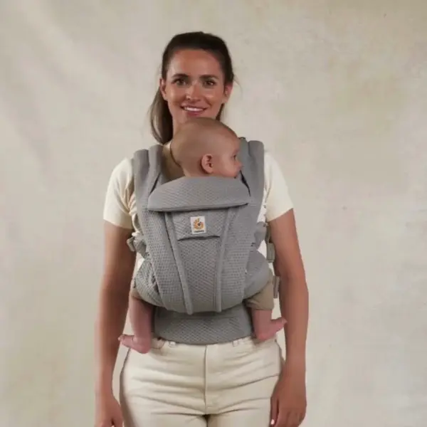 woman wearing the ergobaby omni Convertible baby carrier ergonomic