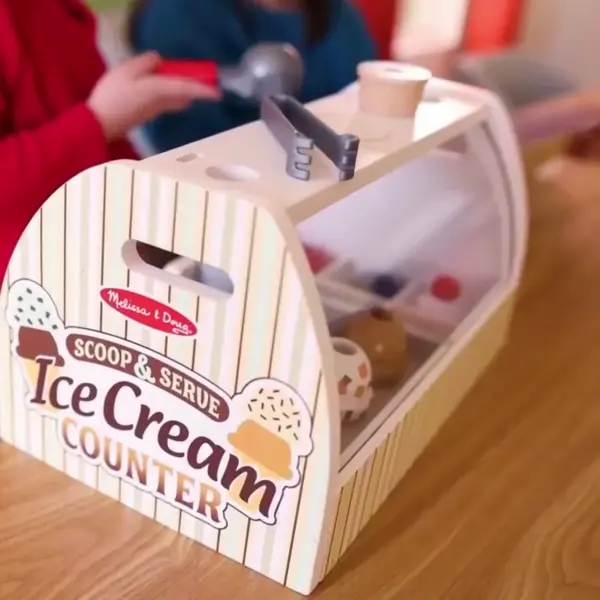 girl and boy playing with melissa and doug ice cream play set