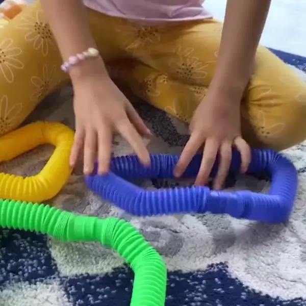 kids playing with pop tubes sensory toys